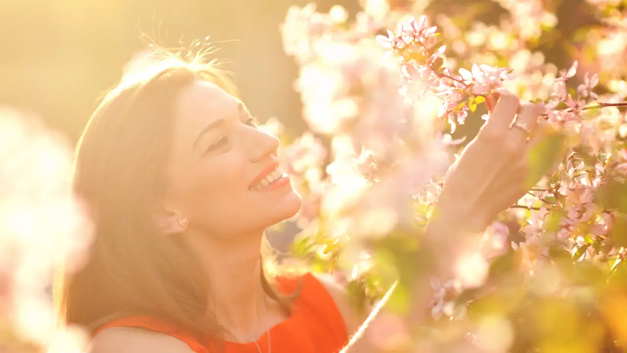 Mujer oliendo flores